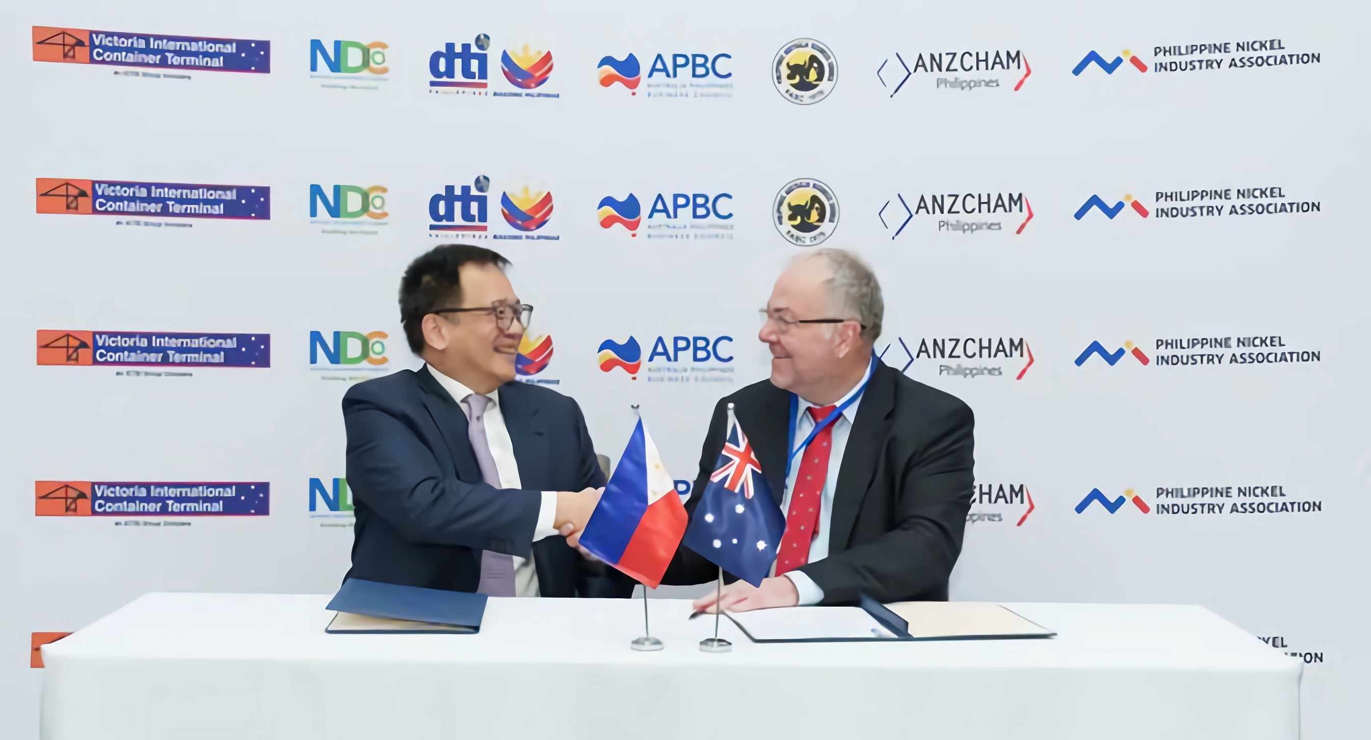 Jerome Tan, president of IMI and Donovan Casey, founder and CEO of RRR Manufacturing PTY Ltd., shake hands to formalize the agreement.